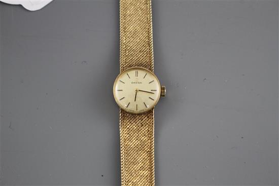 A ladys 1960s? 9ct gold Omega manual wind wristwatch, on integral textured 9ct gold Omega bracelet, gross weight 23.2 grams.